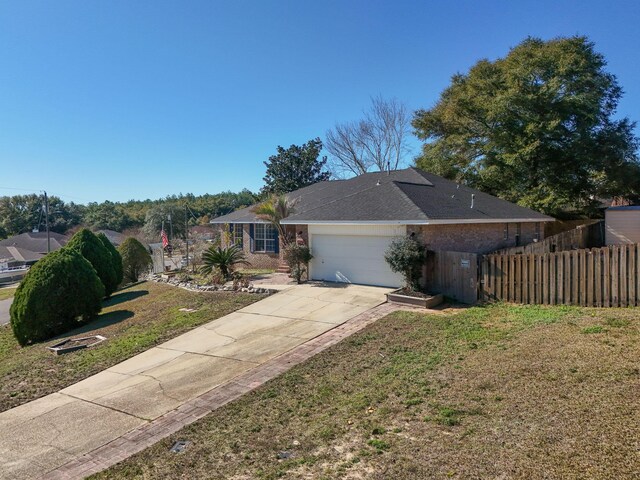 view of front facade with a front yard and a garage