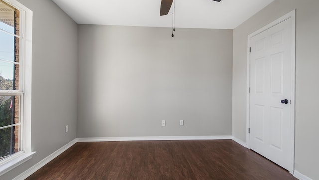 unfurnished room featuring ceiling fan and dark wood-type flooring