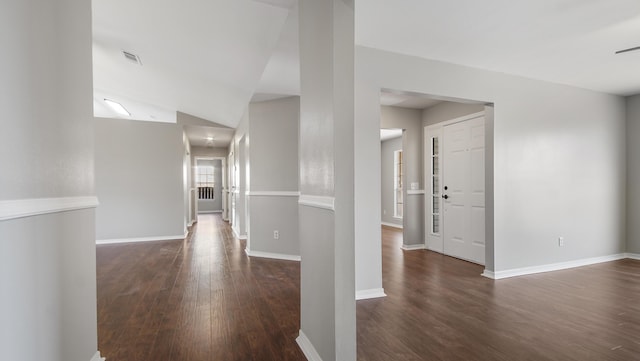 interior space with dark hardwood / wood-style flooring and lofted ceiling