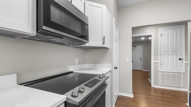 kitchen featuring white cabinets, dark hardwood / wood-style floors, and appliances with stainless steel finishes