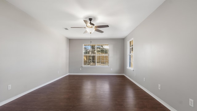 spare room with ceiling fan and dark hardwood / wood-style flooring