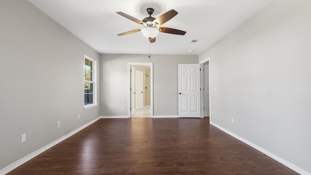 unfurnished room featuring dark hardwood / wood-style floors and ceiling fan