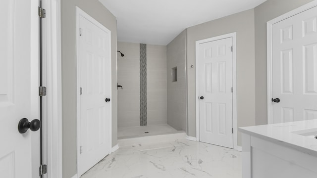 bathroom with vanity and tiled shower