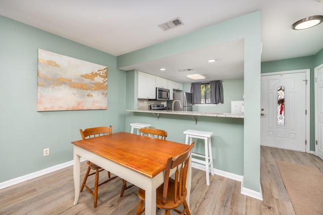 dining room with light hardwood / wood-style floors