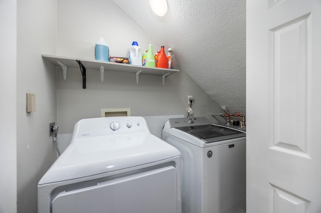 clothes washing area with separate washer and dryer