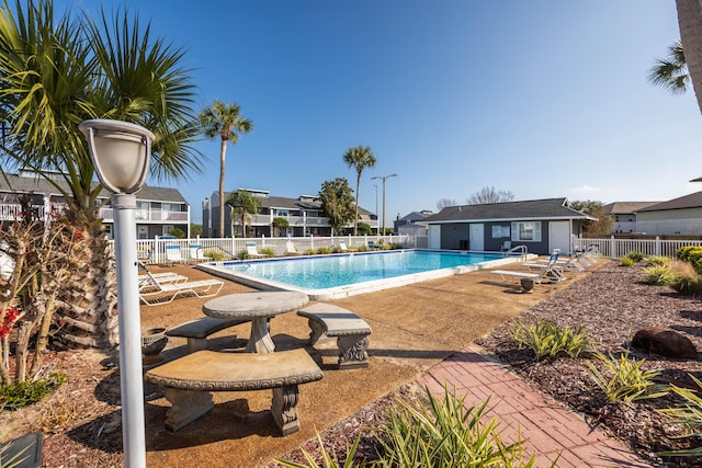 view of swimming pool with a patio area and an outdoor structure