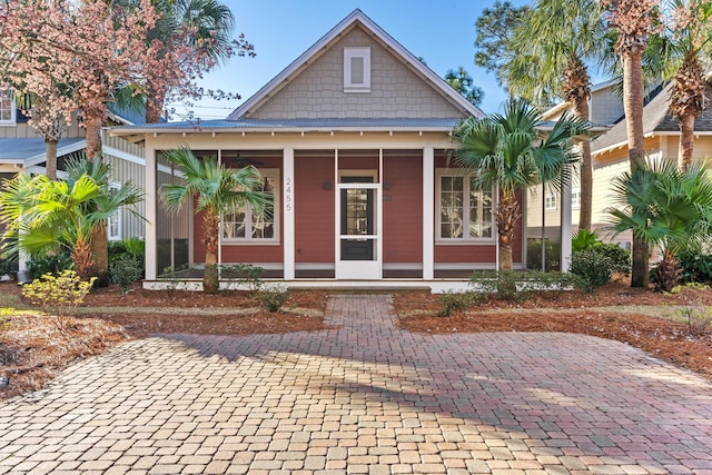 view of front of home featuring a sunroom