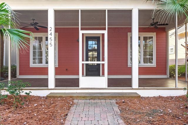 doorway to property with ceiling fan and a porch