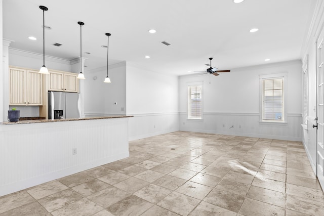 unfurnished living room with ceiling fan and ornamental molding