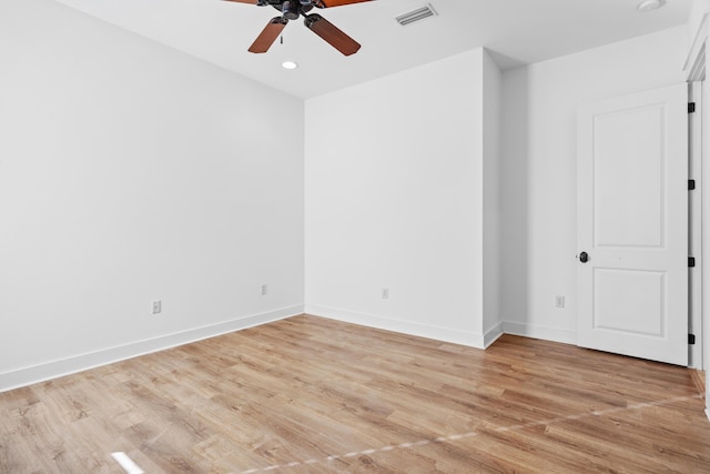 empty room with ceiling fan and light wood-type flooring