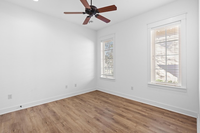 spare room with hardwood / wood-style floors, plenty of natural light, and ceiling fan