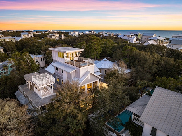 aerial view at dusk with a water view