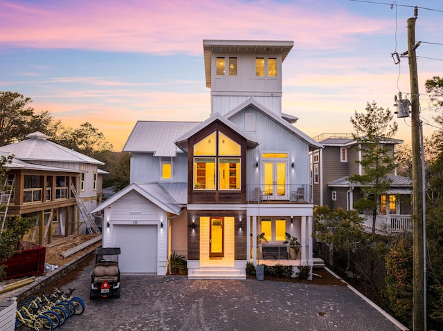 view of front of home featuring a balcony and a garage