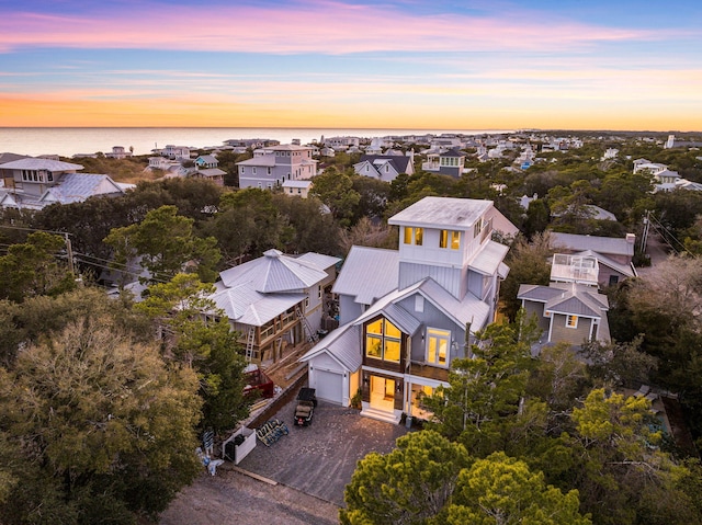 aerial view at dusk with a water view