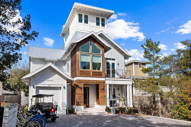 view of front of house with a garage and a balcony