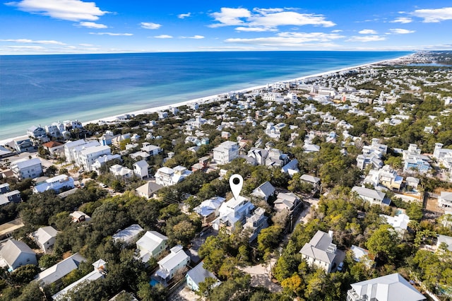 birds eye view of property with a water view and a beach view