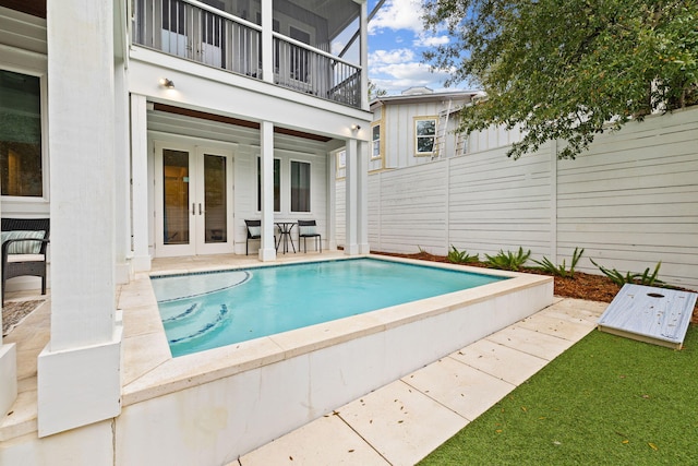 view of pool featuring french doors