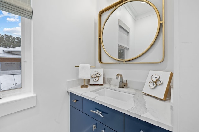 bathroom with ornamental molding and vanity