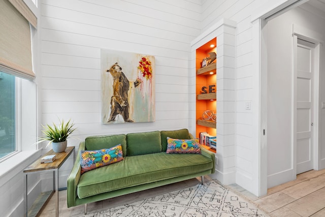 mudroom featuring light hardwood / wood-style floors and wood walls