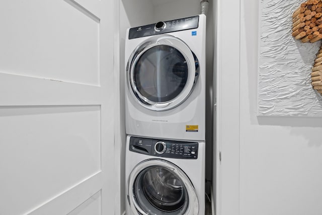 laundry room with stacked washer / drying machine