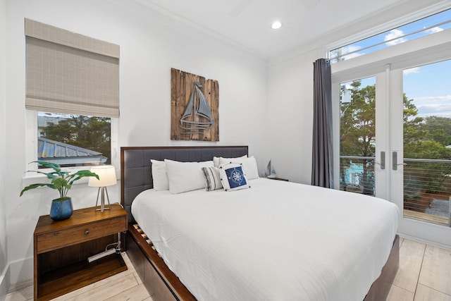 bedroom featuring french doors, ornamental molding, access to exterior, ceiling fan, and light hardwood / wood-style flooring