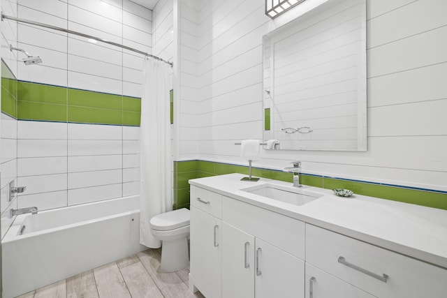 full bathroom featuring shower / bath combo, vanity, and toilet