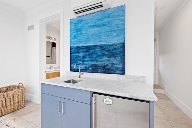 kitchen featuring sink, a wall mounted AC, ornamental molding, light tile patterned flooring, and beverage cooler