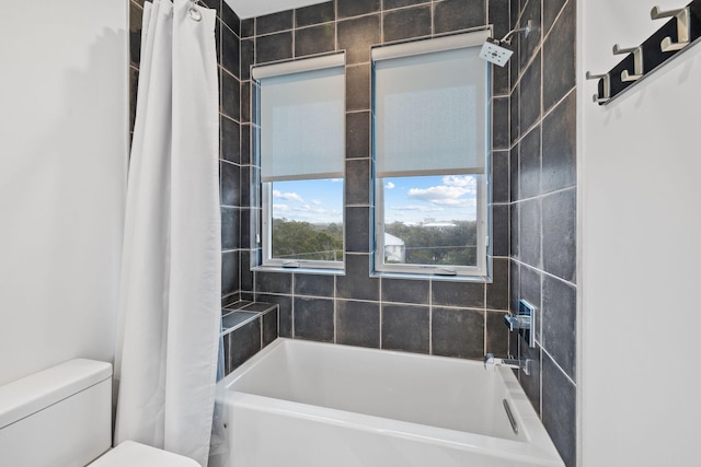 bathroom featuring toilet and shower / bath combo with shower curtain