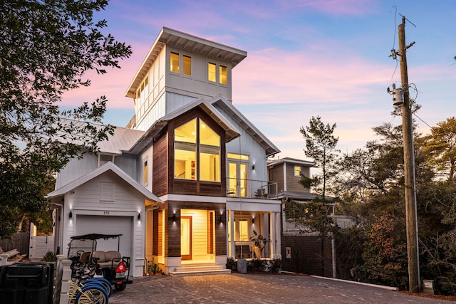 contemporary house with a garage and a balcony