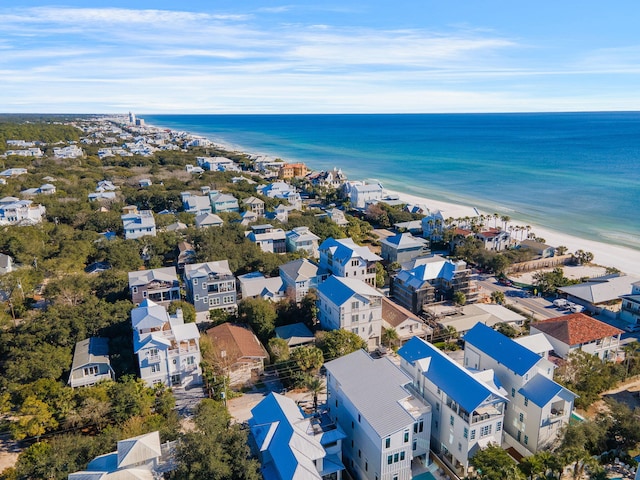 birds eye view of property with a water view and a view of the beach