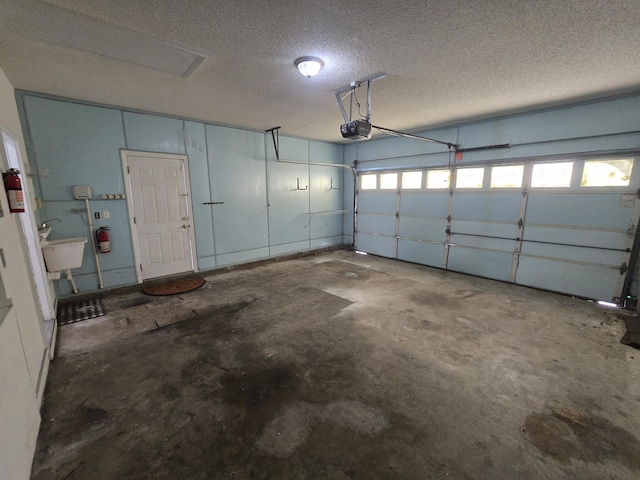 garage featuring sink and a garage door opener