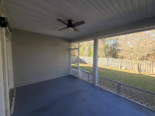 unfurnished sunroom with ceiling fan and wooden ceiling