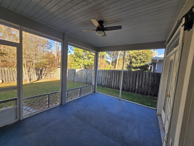 unfurnished sunroom featuring ceiling fan