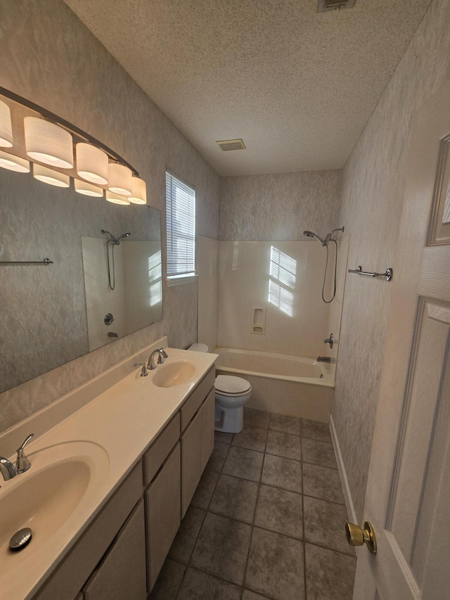 full bathroom featuring tub / shower combination, tile patterned floors, a textured ceiling, toilet, and vanity