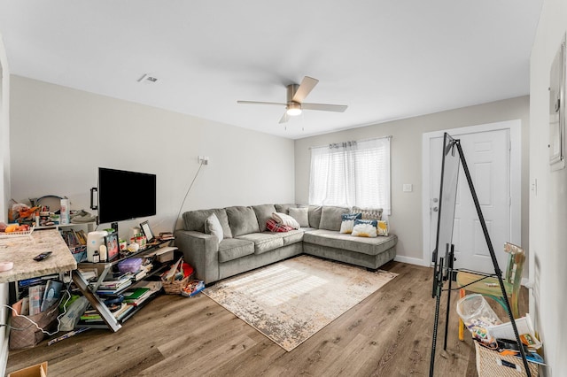 living room with ceiling fan and light hardwood / wood-style floors