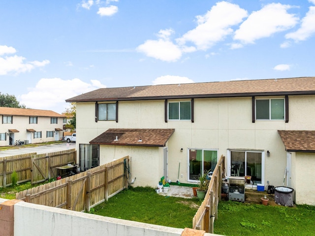 rear view of property with a lawn