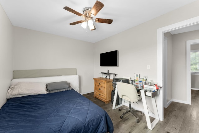 bedroom with ceiling fan and dark hardwood / wood-style flooring