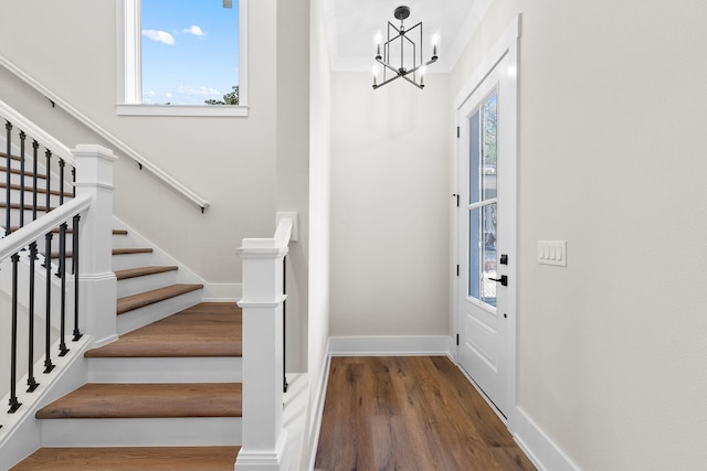 foyer with a chandelier, wood-type flooring, and plenty of natural light