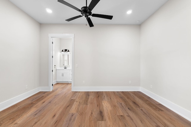 spare room with ceiling fan, sink, and light hardwood / wood-style flooring