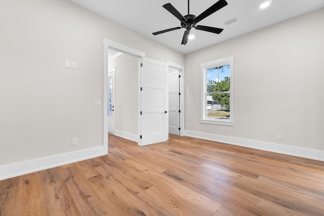 spare room featuring light wood-type flooring and ceiling fan