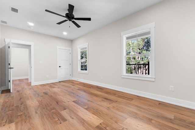 unfurnished bedroom with ceiling fan, light hardwood / wood-style flooring, and multiple windows