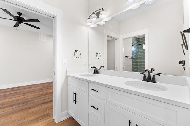 bathroom featuring hardwood / wood-style floors, vanity, ceiling fan, and tiled shower