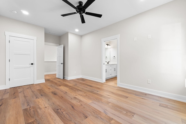 unfurnished bedroom featuring ensuite bathroom, ceiling fan, and light hardwood / wood-style flooring