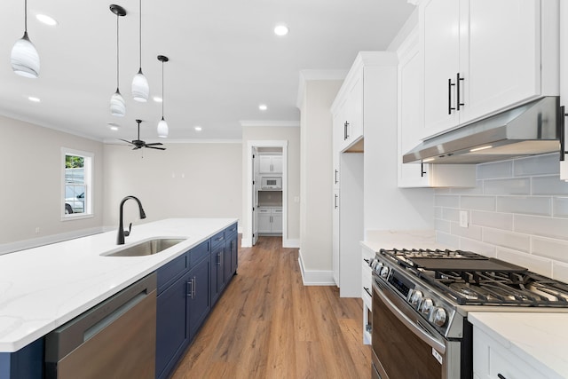 kitchen featuring white cabinetry, sink, pendant lighting, and appliances with stainless steel finishes