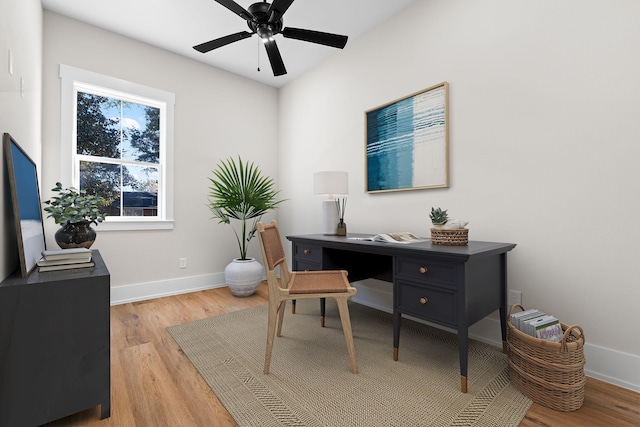 office with ceiling fan and light hardwood / wood-style flooring