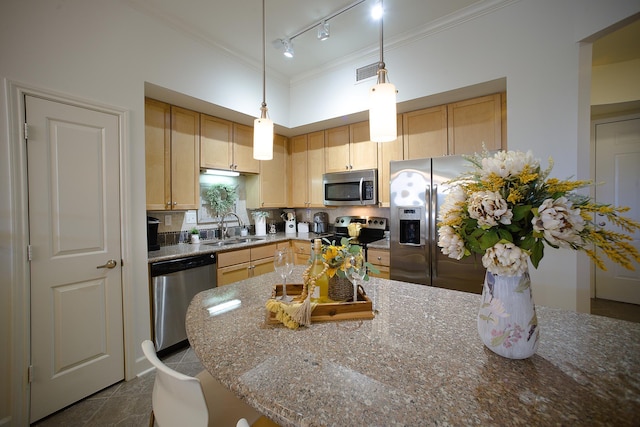 kitchen with light brown cabinets, sink, light stone countertops, and stainless steel appliances