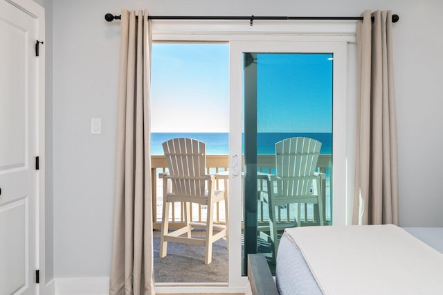 bedroom with multiple windows and a water view