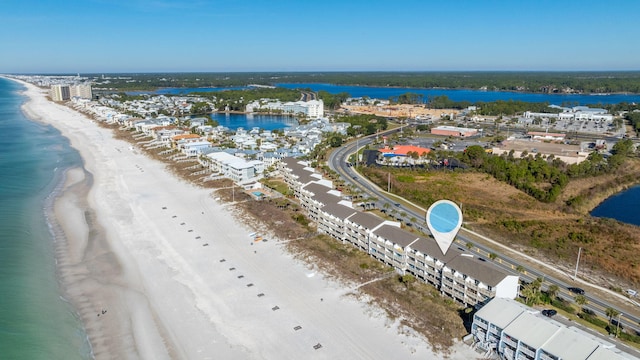 birds eye view of property featuring a water view and a beach view