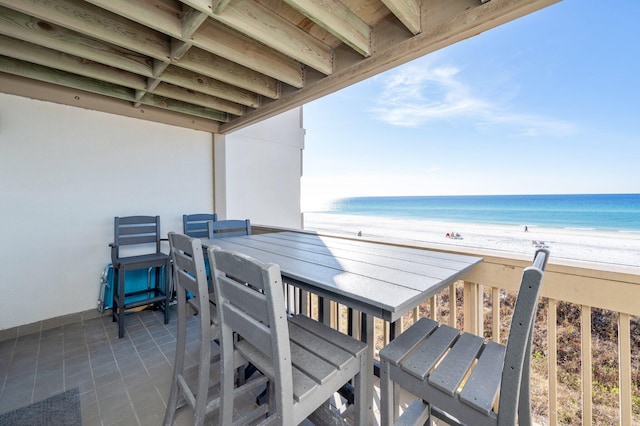 balcony with a water view and a beach view