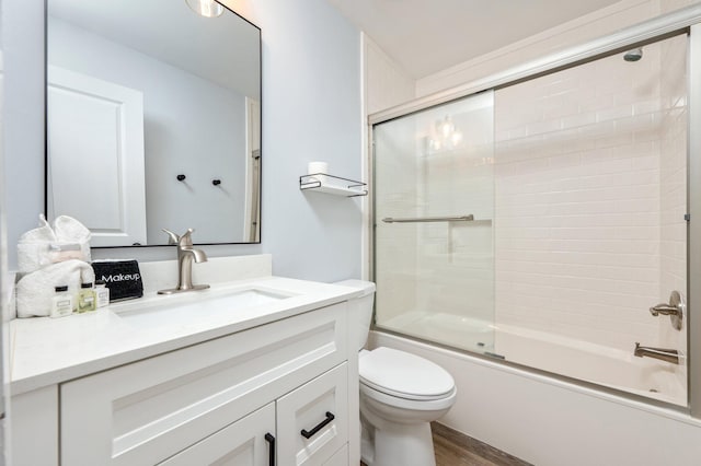 full bathroom with toilet, vanity, enclosed tub / shower combo, and hardwood / wood-style flooring